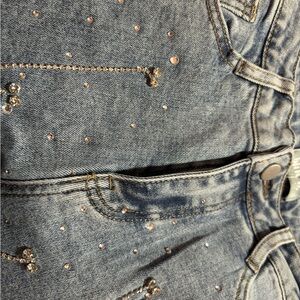 Jeans run a bit small. Rhinestones and fringes are embroidered all over jeans.